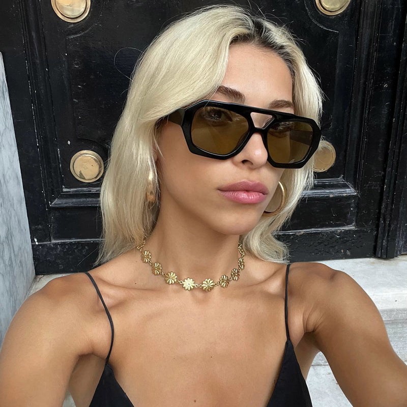 model outside wearing the river sunglasses from vehla eyewear in black khaki